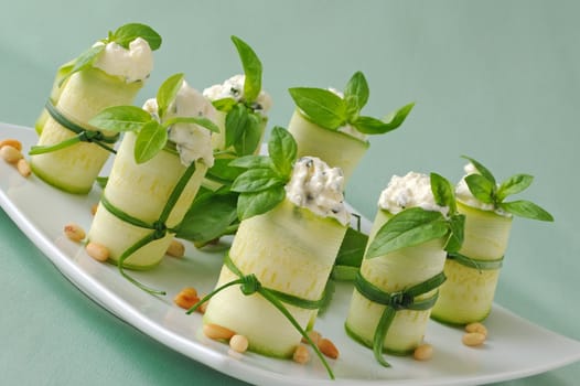 Rolls of zucchini stuffed with ricotta and basil and pine nuts