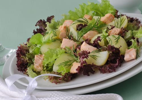 Warm potato salad with salmon salad and sour sauce