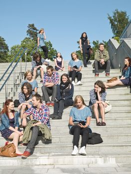 Large group of people sitting in the stairs