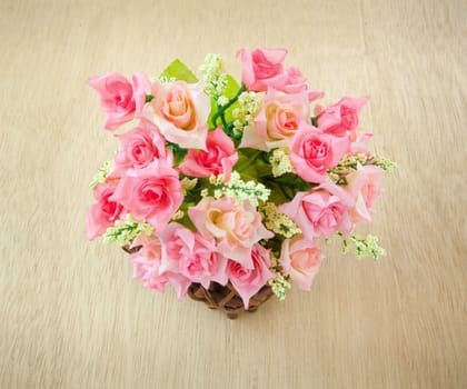 Wood basket roses isolated on wood background