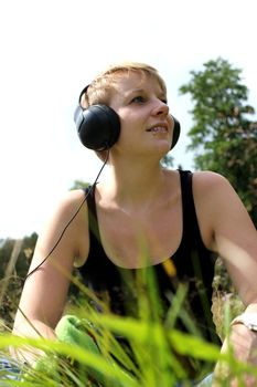 girl on meadow with headphones