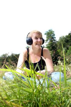 girl on meadow with headphones