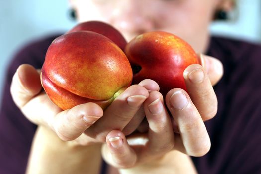 girl holding nectarines