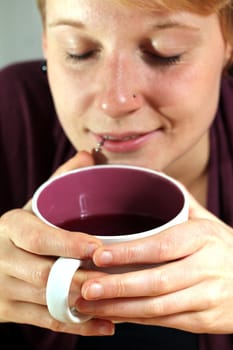 girl is drinking from a cup