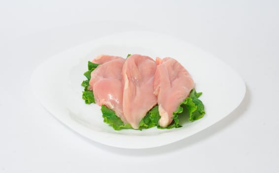 A pair of skinless chicken breasts on a white dish