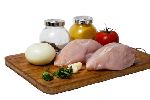 A pair of skinless chicken breasts on a cutting board
