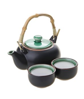 Chinese tea set with cups and tea pot on background.