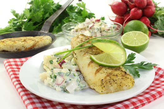 Potato salad with fresh herbs and hake fillet