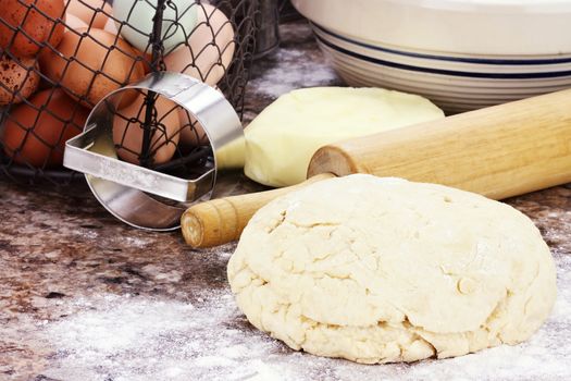 Dough and fresh butter, eggs and flour for making biscuits or bread.  