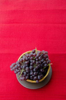 Fresh grape in old bowl on the background