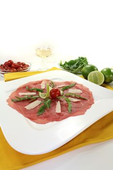 Carpaccio with parmesan, rocket, tomatoes and white wine