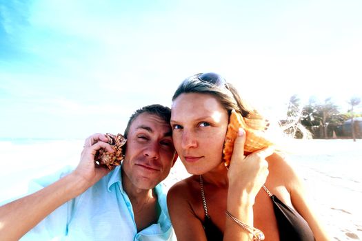 young man and pretty girl speak by shell phones