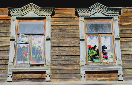 Traditional old Russian windows carved platband of wood house
