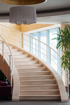 Modern staircase in hotel foyer with daylight from window