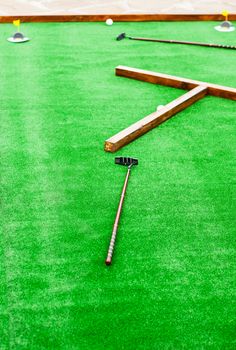 Mini golf field with ball and golf club