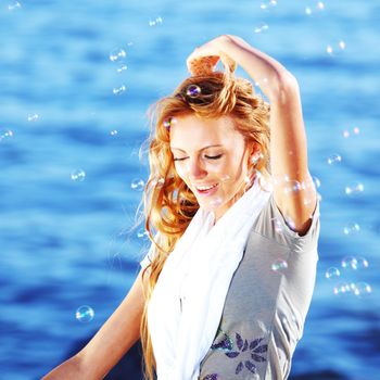 happy blond hair woman sea on background