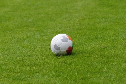 an isolated balloon on a football field