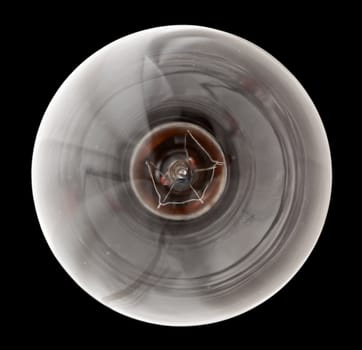 Light bulb illuminated and taken from above and isolated against black