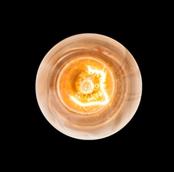 Light bulb illuminated and taken from above and isolated against black