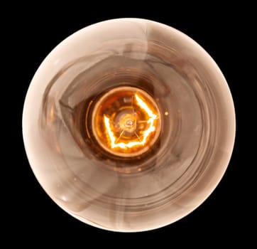 Light bulb illuminated and taken from above and isolated against black