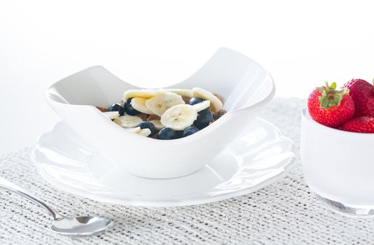 Breakfast of blueberries, bran flakes strawberries with banana
