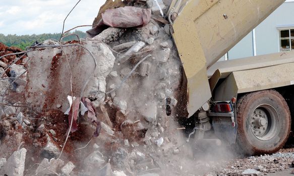 a truck is dumping rubble