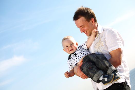 father and son in blue sky