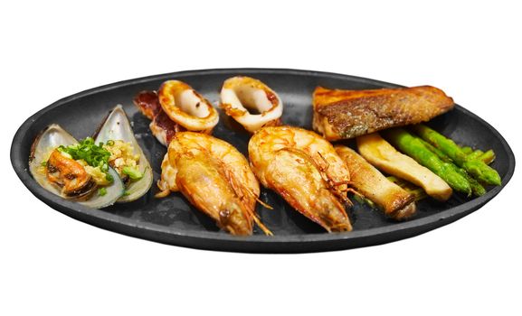 Seafood steak with prawns mussels and salmon isolated on white background