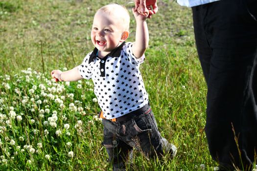 father and son walking on grass