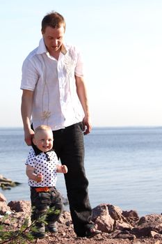 father and son walking on grass