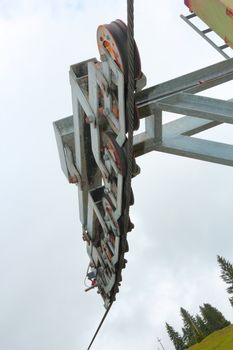 ski lift wheels over the cloudy spring sky