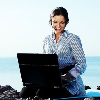 woman with laptop sea background