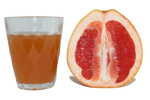 Grapefruit juice in a glass and the grapefruit cut half-and-half on a white background