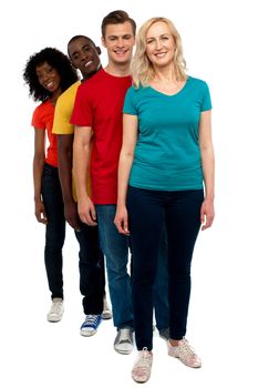 Friends standing behind beautiful caucasian woman and smiling at camera