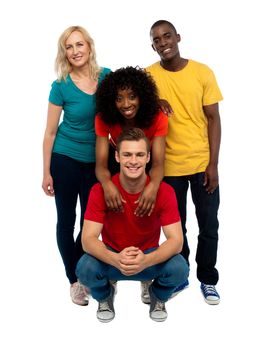 Group of four happy young people. Causal college mates posing in style