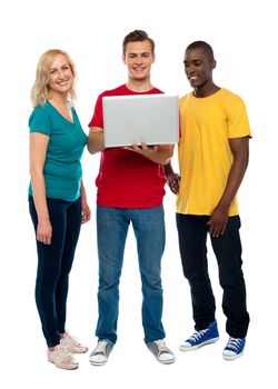 Full length shot of teenagers with laptop isolated over white background