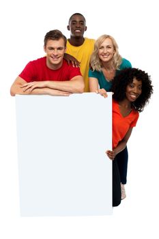 Group of teenagers displaying white banner in front of camera