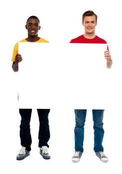 Trendy young guys presenting blank banner ad isolated over white background