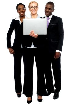 Group of business people looking into laptop. Full length portrait