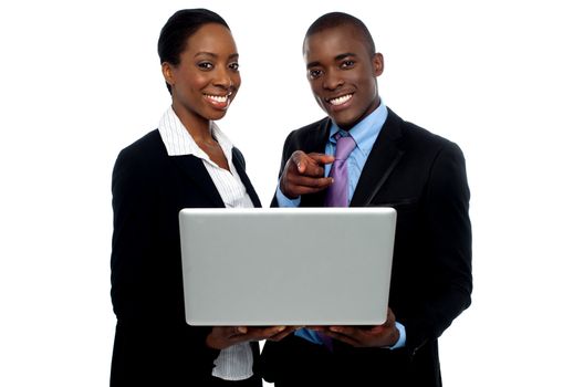 African coworkers operating laptop and pointing. Al on white background