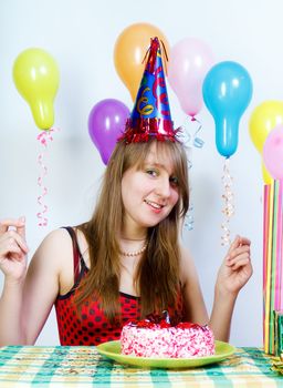Birthday. Young fun happy girl with cake and balloons