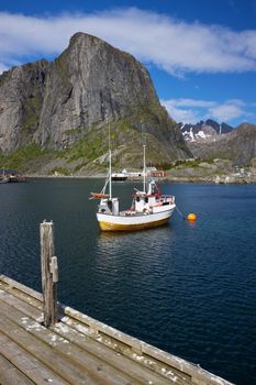 Fishing boat in fjord on Lofoten islands in Norway