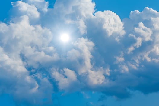 Cloud and sunbeam in blue sky