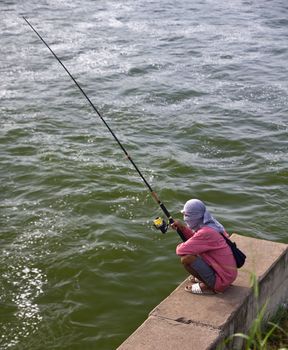 Fishermen waiting to catch a fish hook