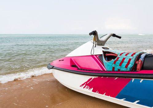 Pink  jet ski close up parked on the beach