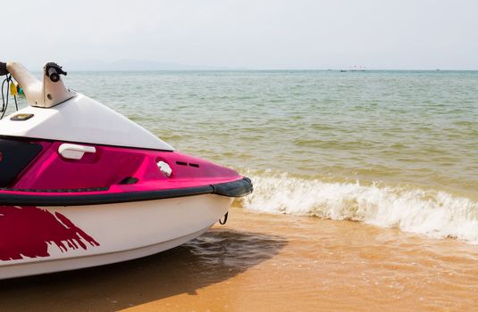 Pink  jet ski close up parked on the beach