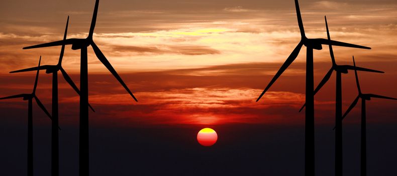 wind turbine generator with sunset on background