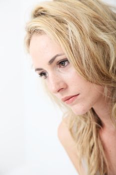 Closeup studio portrait of a beautiful woman daydreaming with a gentle tender expression on her face Closeup studio portrait of a beautiful woman daydreaming with a gentle tender expresion on her face 
