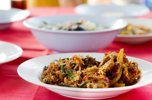  stir fried  fish with  spicy sauce on table