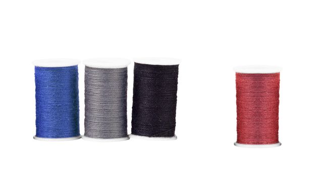 Colourful spools of thread isolated on white background